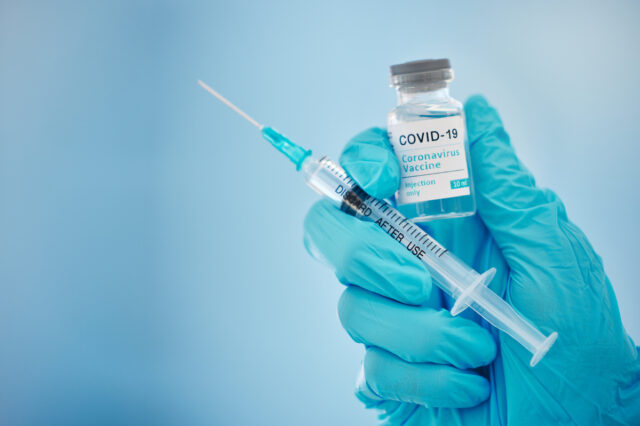 Doctor, hands and covid vaccine for cure, healthcare or medical syringe medication to combat the virus. Hand of nurse holding corona virus sample with needle for vaccination from illness or disease.